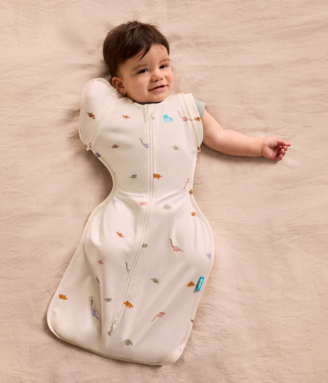 Swaddle Up™ 2-in-1 Übergangspucksack 1.0 TOG Baumwolle Creme Dino-Schnarch